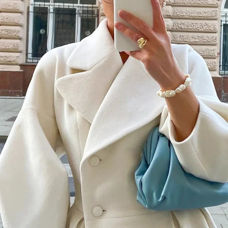 Women's white belted long coat featuring a wide collar, crafted from soft cotton blend for comfort and style.