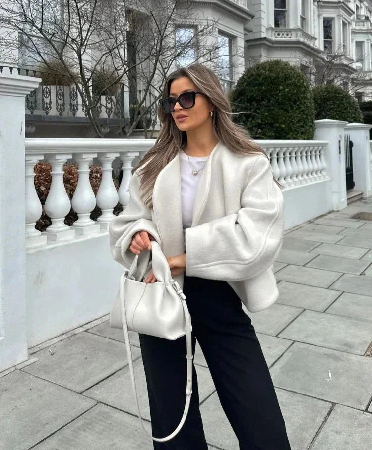 Women's white short coat featuring oversized sleeves, made from a soft cotton blend, perfect for a stylish casual look.