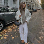 Women's white short coat featuring oversized sleeves, crafted from lightweight fabric for a relaxed fit and modern style.