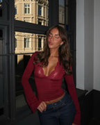 Women's wine lace V-neck top featuring delicate flare sleeves, made from soft fabric for a comfortable fit.