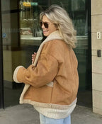 Brown women's winter coat featuring a cozy sherpa lining, button front, and side pockets for warmth and style.
