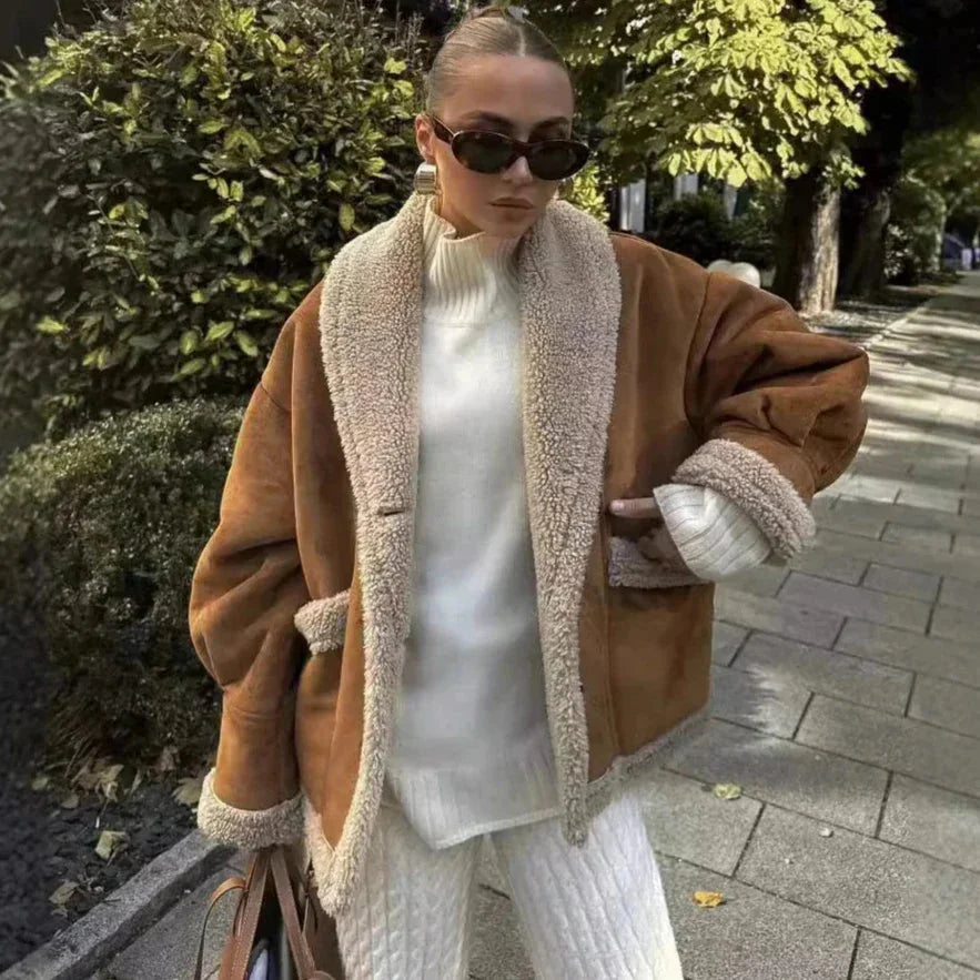 Brown women's winter coat featuring a cozy sherpa lining, designed for warmth and comfort in cold weather.