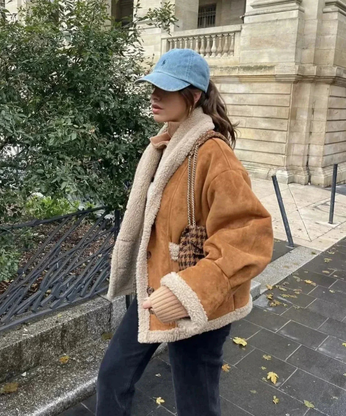 Brown women's winter coat featuring a soft sherpa lining and a stylish hood for warmth and comfort during cold weather.