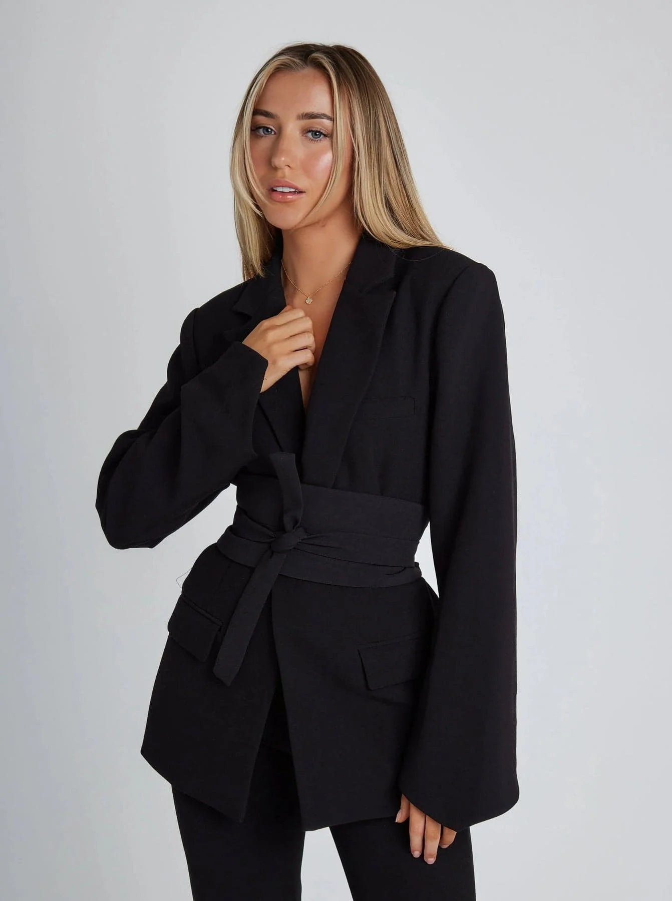 Women's wrap blazer made of soft fabric, featuring a tie waist, long sleeves, and a modern silhouette for versatile styling.