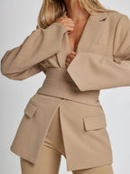 Women's wrap blazer with tie waist, long sleeves, and soft fabric; versatile design for both office and casual wear.