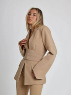 Women's wrap blazer with tie waist, long sleeves, made from lightweight fabric, features a tailored fit for versatile…