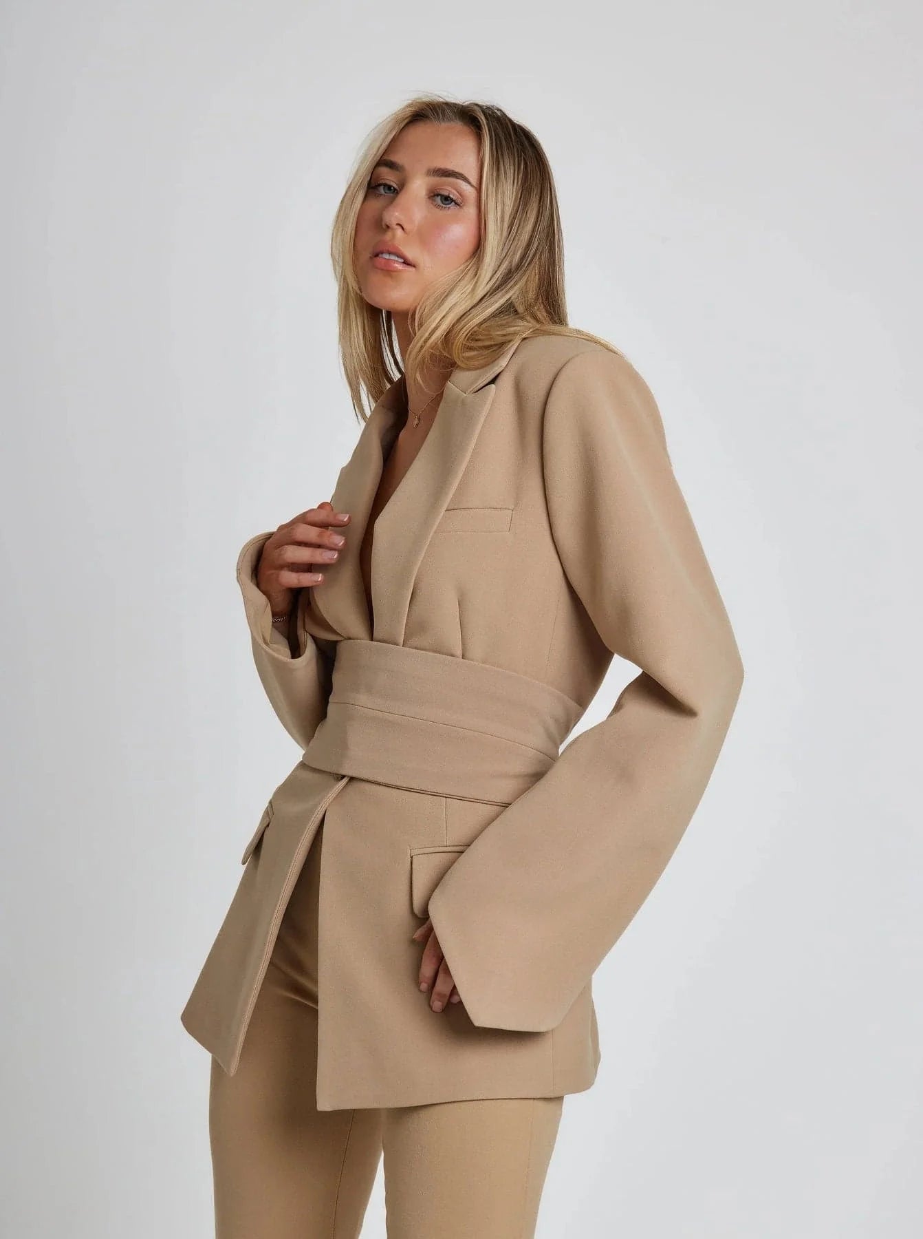 Women's wrap blazer with tie waist, long sleeves, made from lightweight fabric, features a tailored fit for versatile…