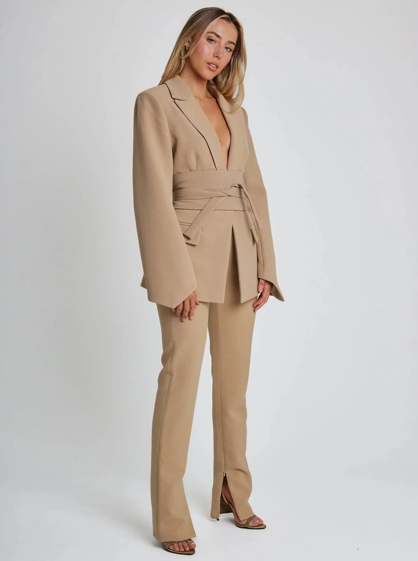 Women's wrap blazer with tie waist, long sleeves, made from lightweight fabric for a comfortable, tailored fit.