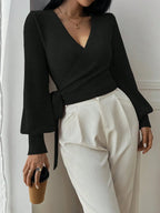 Women's wrap knit cardigan with tie waist, featuring soft fabric, long sleeves, and an open front for a relaxed fit.