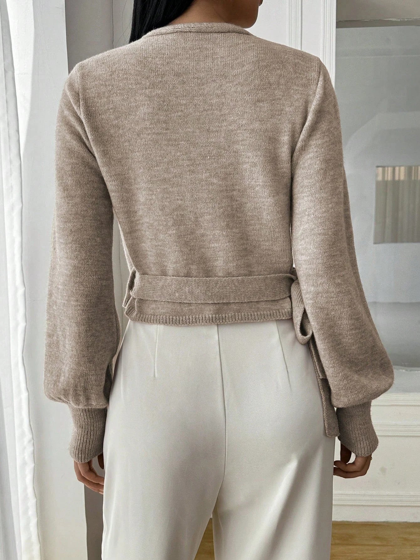 Women's wrap knit cardigan with tie waist, crafted from soft, breathable yarn with a cozy, open-front design.