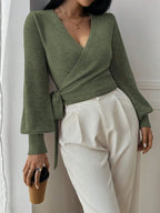 Women's wrap knit cardigan in soft fabric with a tie waist for adjustable fit, featuring long sleeves and a cozy design.