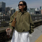 Women's zip-up bomber jacket featuring long sleeves, a classic lapel, made from soft, durable fabric for casual wear.