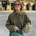 Women's zip-up bomber jacket with long sleeves, lapel collar, made from lightweight fabric with practical side pockets.