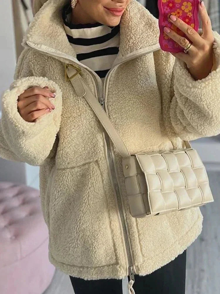 Women's zip-up fleece jacket with stand collar, soft polyester material, lightweight design, perfect for layering and warmth.